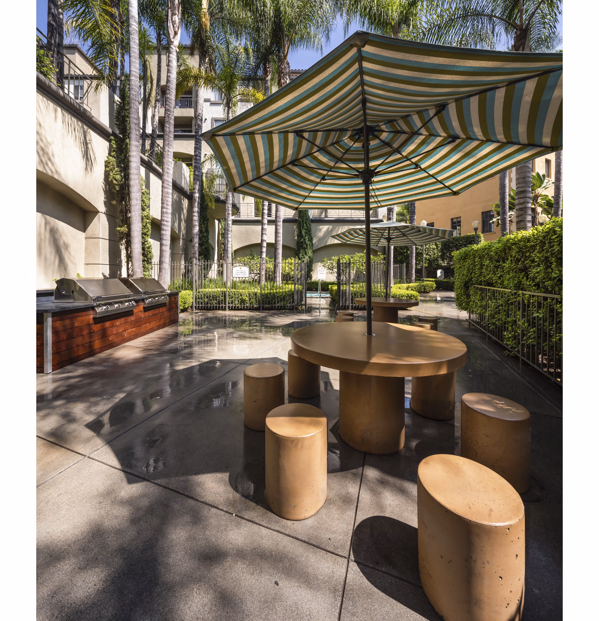 Outdoor grill area with modern barbeque stations at Holly Street Village Apartments
