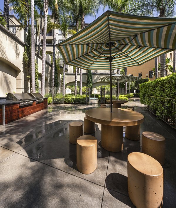 Outdoor grill area with modern barbeque stations at Holly Street Village Apartments