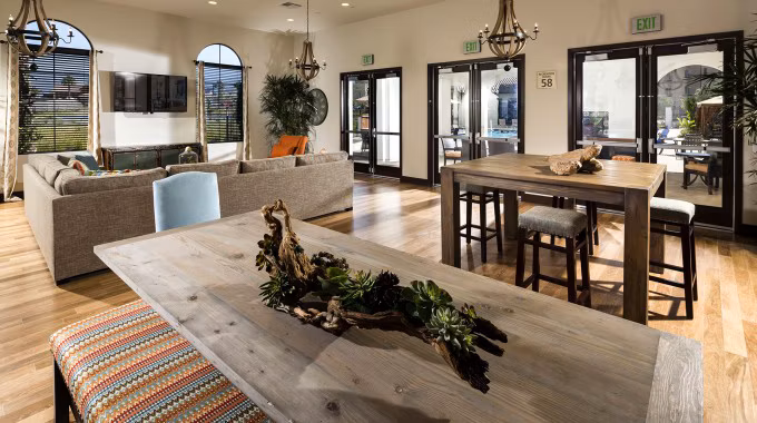 Elegant clubhouse with modern decor at Montecito at Dos Lagos Apartments, featuring spacious lounging areas and a billiards table