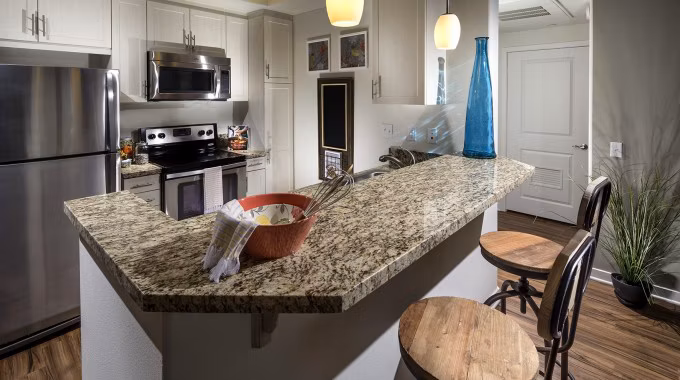 Montecito at Dos Lagos Apartments: Modern kitchen with stainless steel appliances and granite countertops