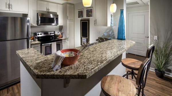 Montecito at Dos Lagos Apartments: Modern kitchen with stainless steel appliances and granite countertops