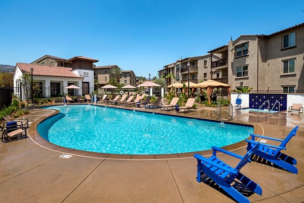 Sparkling pool surrounded by palm trees at Montecito at Dos Lagos Apartments, perfect spot for relaxation and leisure outdoors