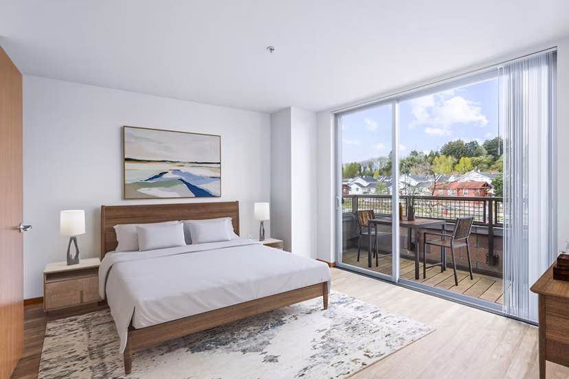 Cozy bedroom with modern furnishings at The Station at Othello Park Apartments