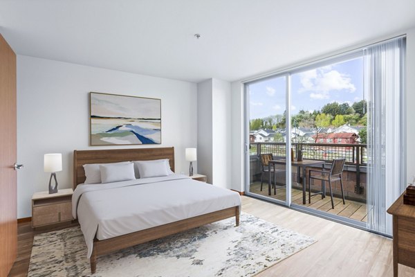 Cozy bedroom with modern furnishings at The Station at Othello Park Apartments