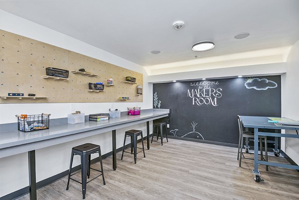 Clubhouse with modern design and communal spaces at The Station at Othello Park Apartments