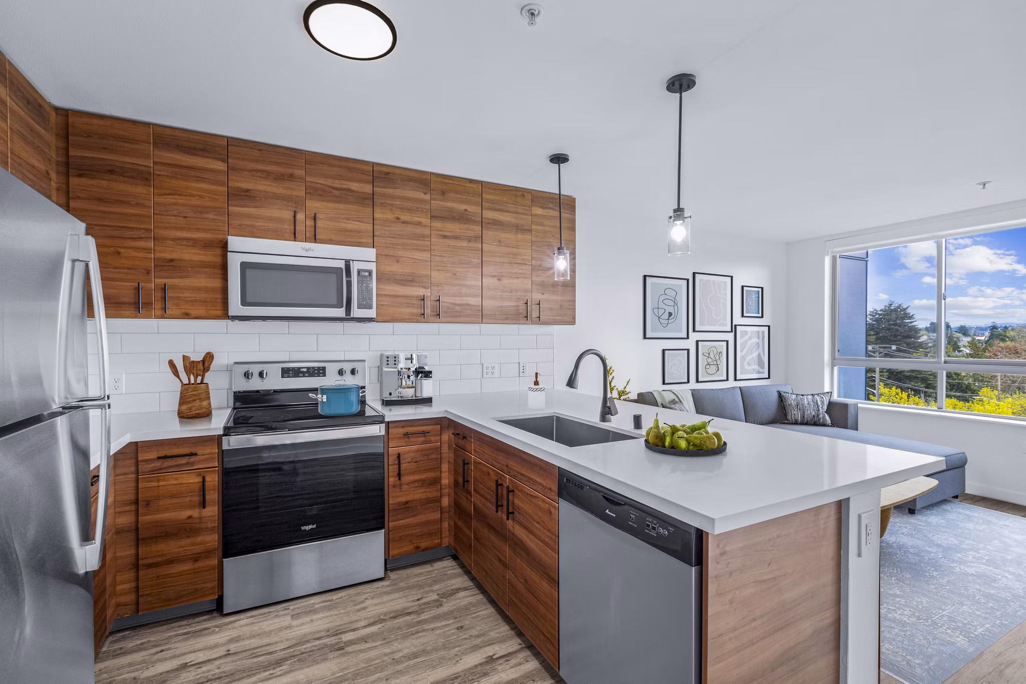 Kitchen featuring modern appliances and sleek countertops at The Station at Othello Park Apartments