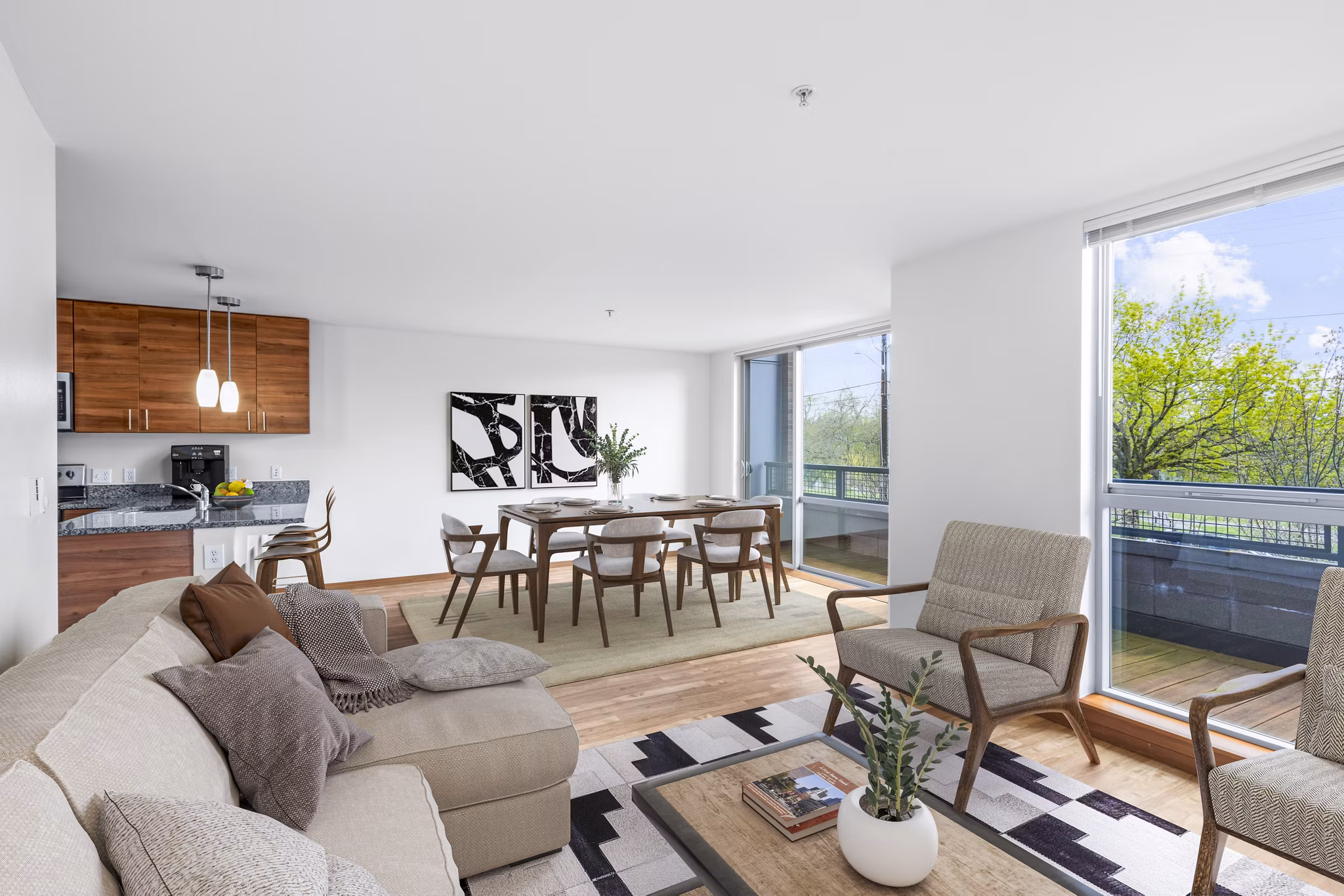 Modern living room with plush seating and natural light at The Station at Othello Park Apartments