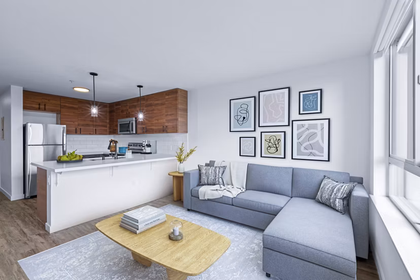 Spacious living room with modern decor in The Station at Othello Park Apartments