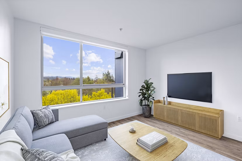 Spacious living room with modern furnishings at The Station at Othello Park Apartments, ideal for urban living in a Seattle community