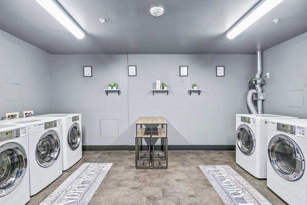 Laundry facility at The Station at Othello Park Apartments offering state-of-the-art washers and dryers for residents