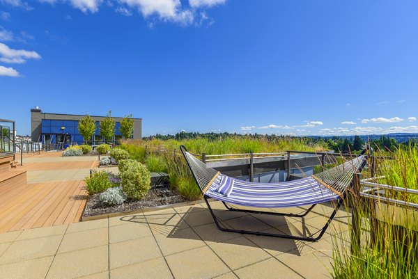 Modern patio area with sleek furniture at The Station at Othello Park Apartments, offering comfortable outdoor living in urban Seattle environment