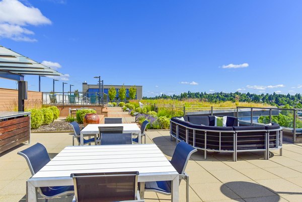 Grill area with seating at The Station at Othello Park Apartments, perfect for outdoor dining and relaxation