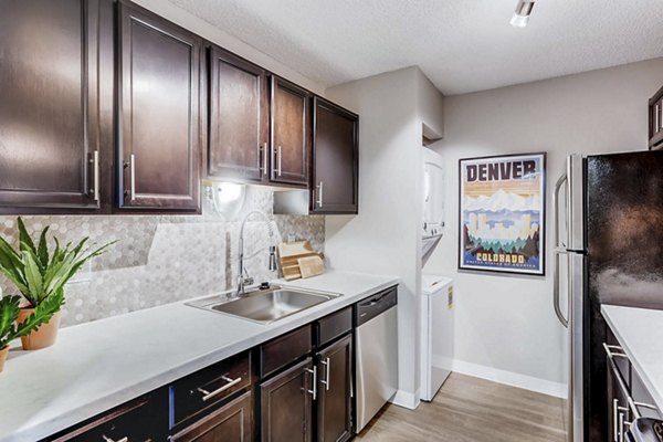 Sleek kitchen with stainless steel appliances at Sage at Panorama Apartments