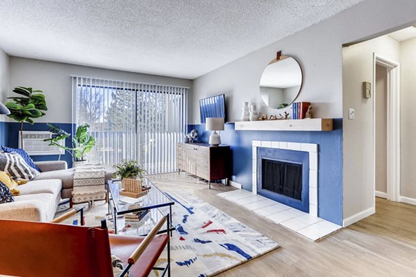 Cozy living room with modern furniture and ample natural light in Sage at Panorama Apartments