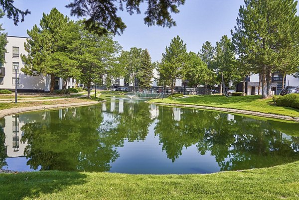 Landscaped area with a serene pond and greenery at luxury apartments