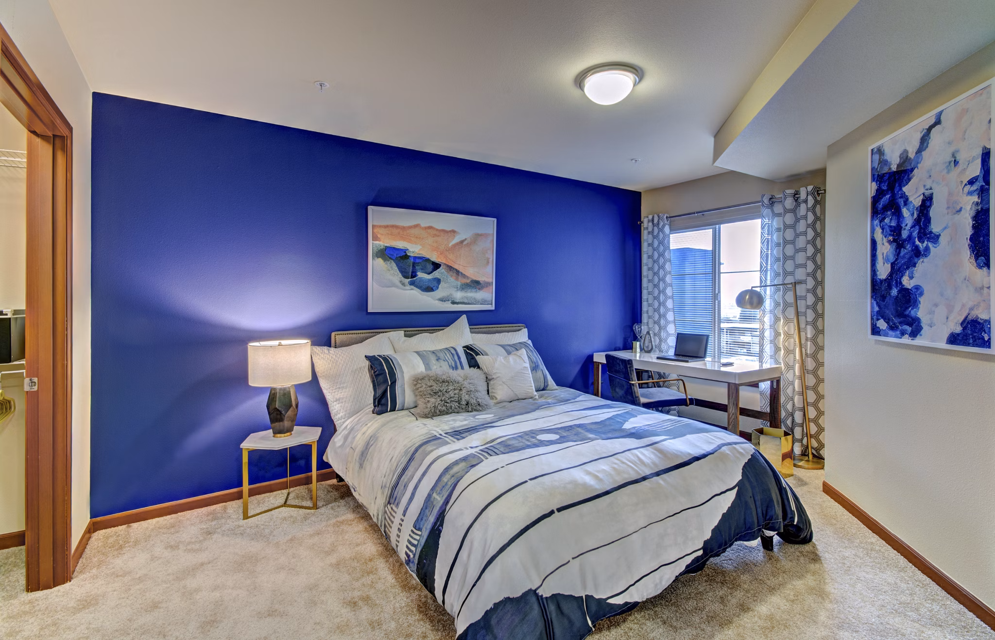 Cozy bedroom with modern decor at Harrington Square Apartments, a luxury property by Greystar