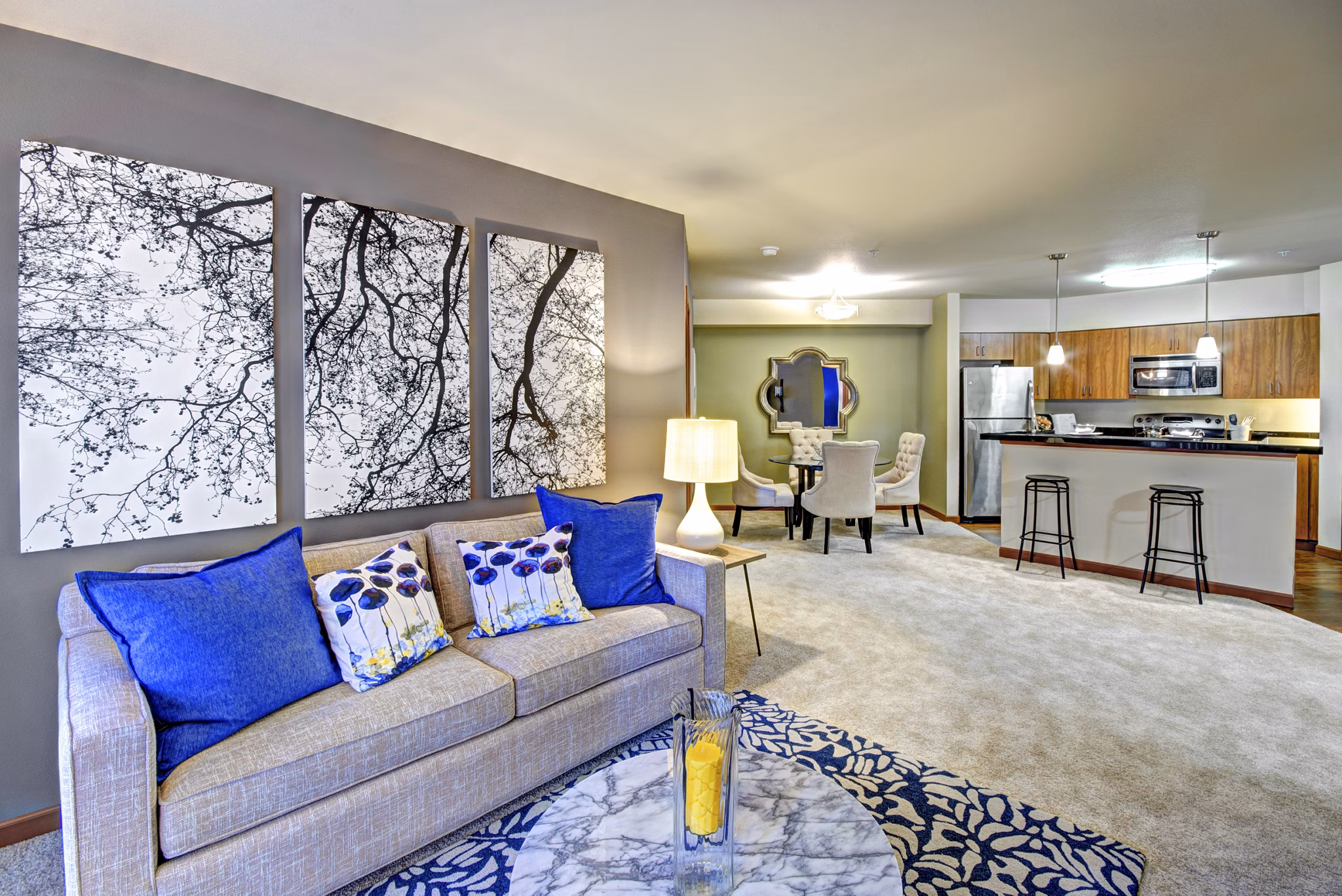 Modern living room with cozy furnishings at Harrington Square Apartments featuring elegant decor and ample natural light