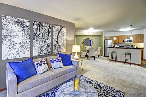 Modern living room with cozy furnishings at Harrington Square Apartments featuring elegant decor and ample natural light