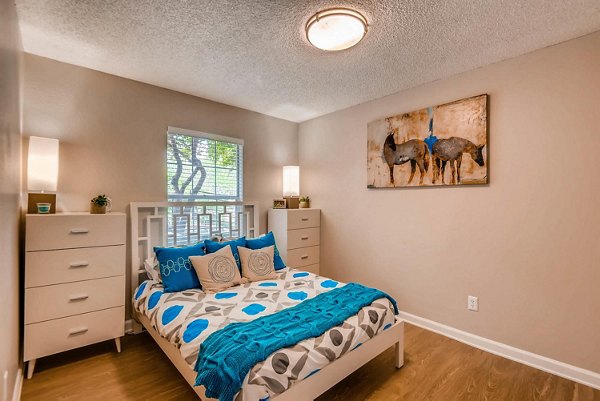 The Eva Apartments: Stylish bedroom with modern furnishings in luxury Greystar community