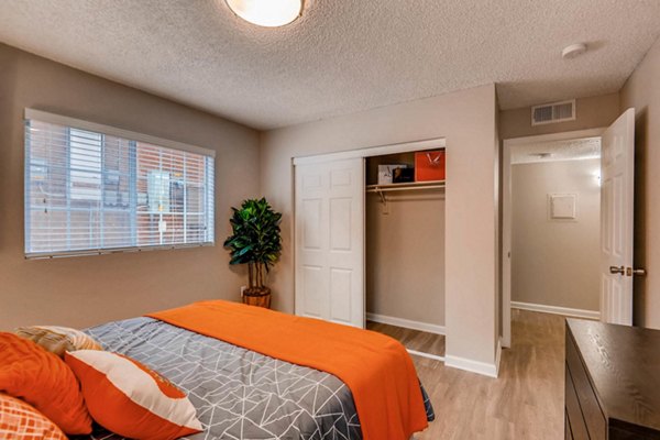Cozy bedroom with modern furnishings and large window in The Eva Apartments