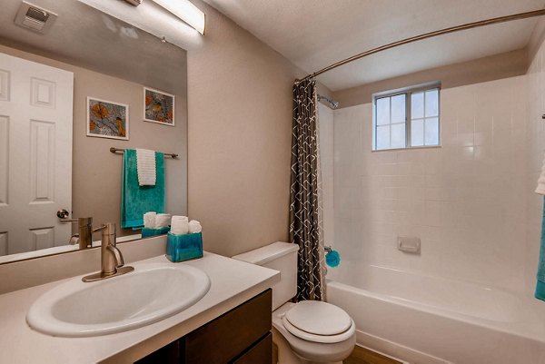 Elegant bathroom with marble countertops and modern fixtures at The Eva Apartments
