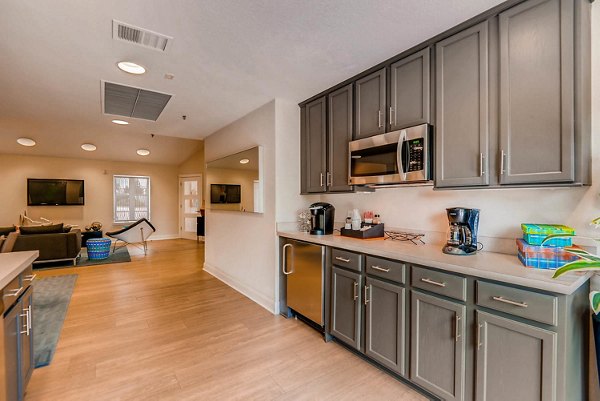 Clubhouse with modern seating and large windows at The Eva Apartments, a Greystar luxury property