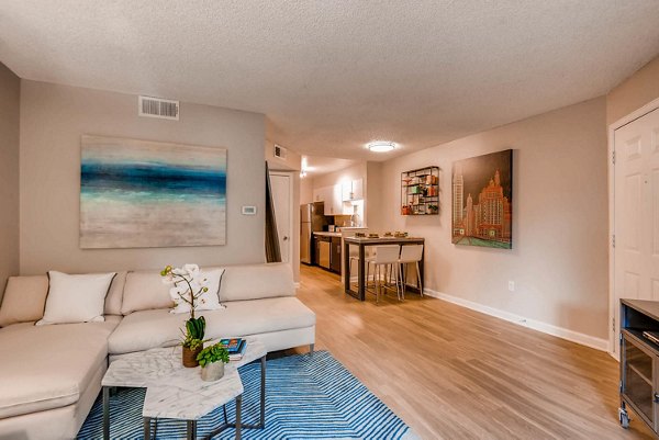Spacious living room with modern decor at The Eva Apartments, featuring luxury amenities for comfortable city living