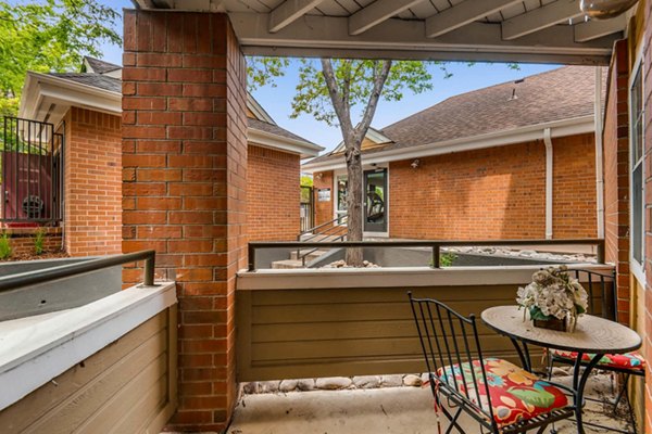 Chic outdoor patio with modern seating at The Eva Apartments, offering a luxurious retreat in a serene setting