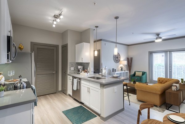 Modern kitchen featuring stainless steel appliances in Deseo at Grand Mission Apartments