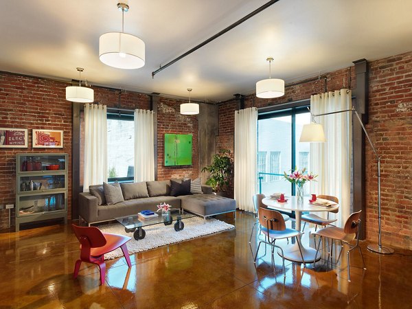 Bright living room with modern decor at Arc Light Apartments, featuring comfortable seating and large windows