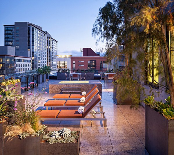 Sunny patio with comfortable seating at Arc Light Apartments, ideal for outdoor relaxation and gatherings