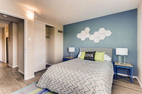 Lakeview Towers at Belmar Apartments: Stylish bedroom with plush bedding and large windows offering natural light