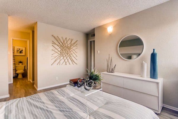 Cozy bedroom with modern furnishings at Lakeview Towers at Belmar Apartments, showcasing luxury living spaces
