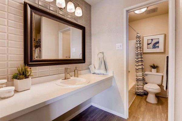 Bathroom with elegant marble countertops and modern fixtures in Lakeview Towers at Belmar Apartments