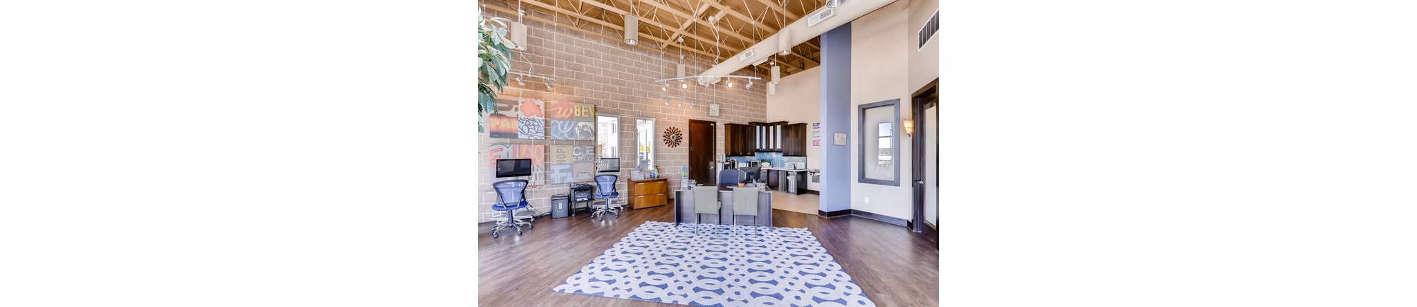 Modern clubhouse with cozy seating and fireplace at Lakeview Towers at Belmar Apartments