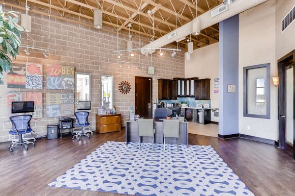 Modern clubhouse with cozy seating and fireplace at Lakeview Towers at Belmar Apartments