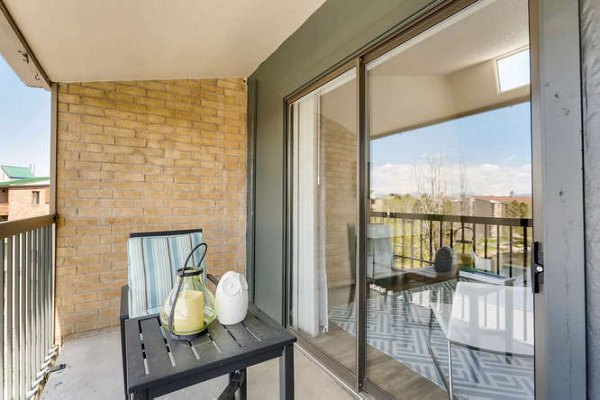 Cozy outdoor patio with seating at Lakeview Towers at Belmar Apartments, perfect for social gatherings or relaxing moments