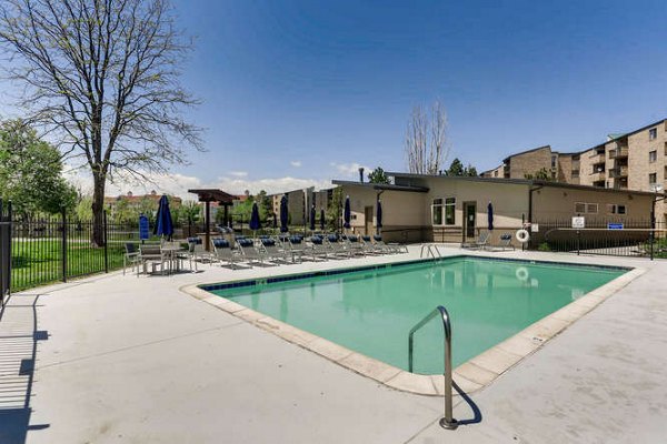 Resort-style pool at Lakeview Towers at Belmar Apartments with shaded lounge chairs and landscaped surroundings