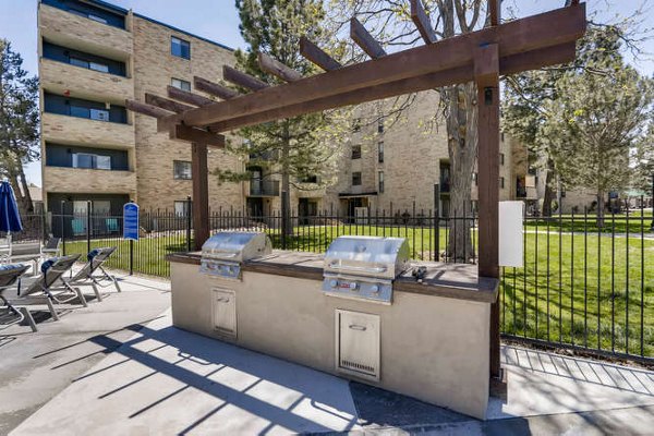 Grill area with outdoor seating at Lakeview Towers at Belmar Apartments: Perfect spot for BBQs and social gatherings