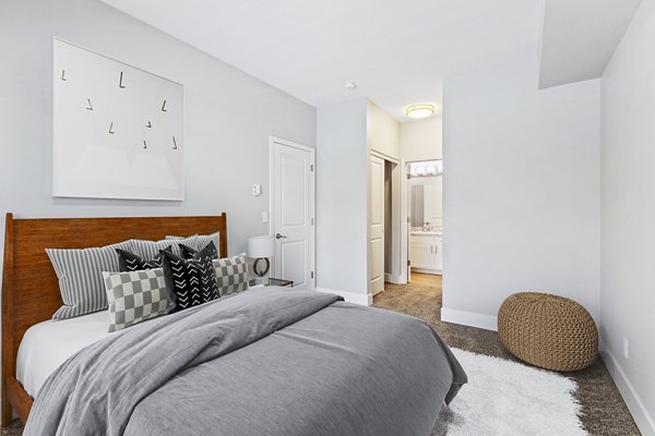 Cozy bedroom with modern furnishings at Big Trout Lodge Apartments, offering luxurious and comfortable living spaces