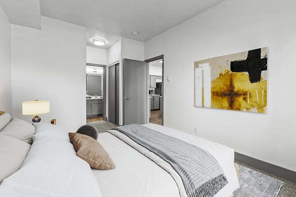 Cozy bedroom featuring elegant decor and large windows at Big Trout Lodge Apartments