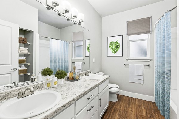 Modern bathroom with double vanity and sleek fixtures in Big Trout Lodge Apartments, luxury living spaces by Greystar