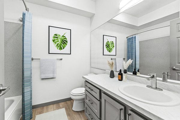 Modern bathroom with sleek fixtures and ample lighting at Big Trout Lodge Apartments