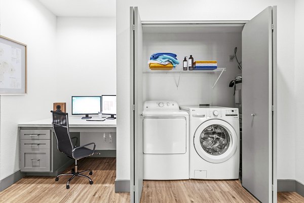 Home office and laundry room with bright lighting at Big Trout Lodge Apartments