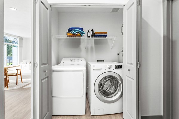Laundry room with modern appliances in Big Trout Lodge Apartments