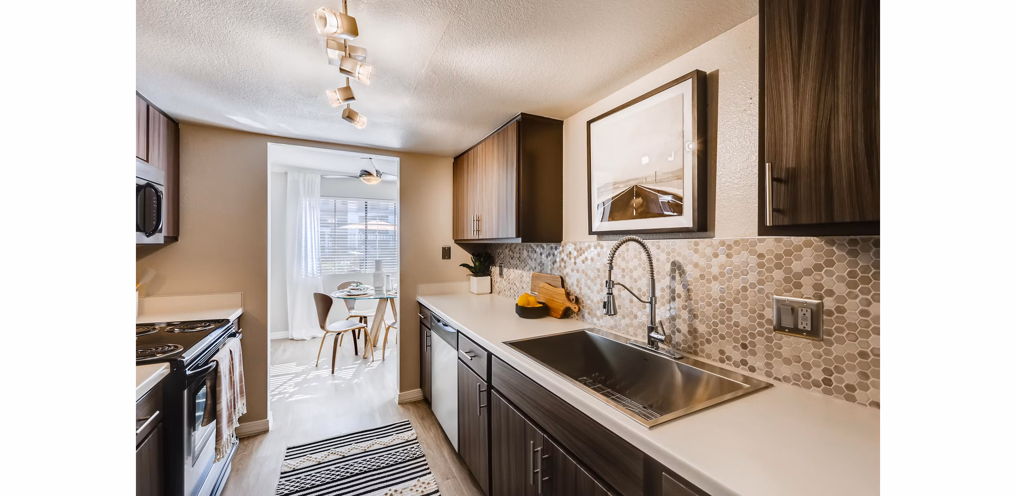 Modern kitchen with stainless steel appliances at Chazal Scottsdale Apartments, offering luxury living in Scottsdale