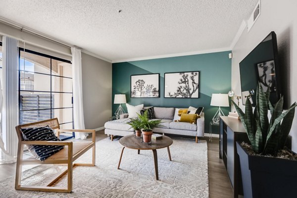 Spacious living room with modern decor and natural lighting at Chazal Scottsdale Apartments