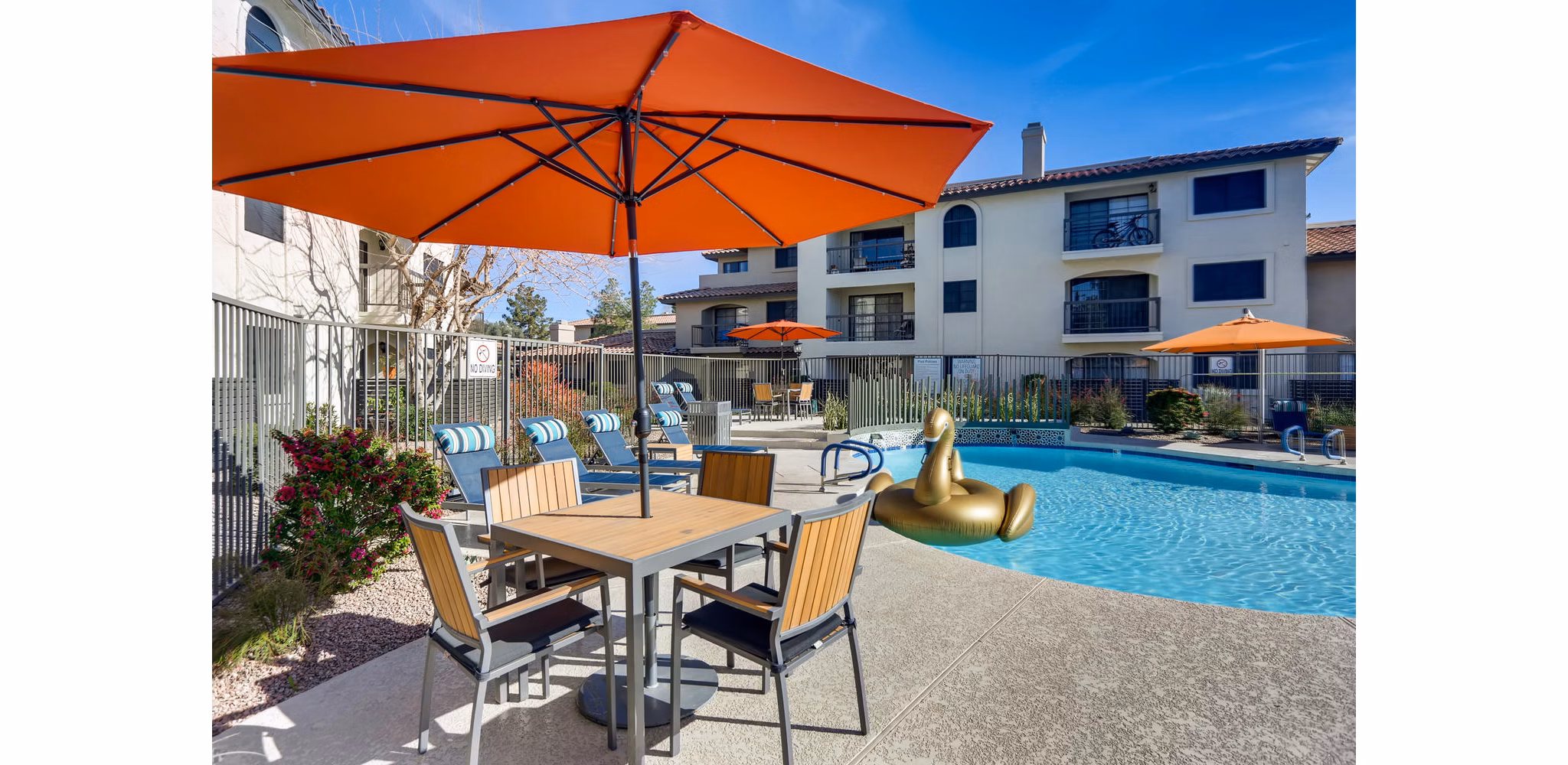 Luxurious resort-style pool at Chazal Scottsdale Apartments with surrounding palm trees, offering a serene outdoor experience for residents
