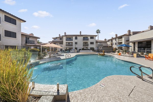 Luxurious outdoor pool with sun loungers at Chazal Scottsdale Apartments