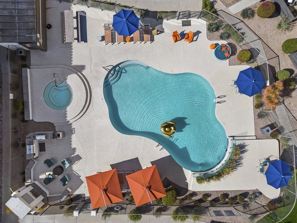 Chazal Scottsdale Apartments: Luxurious pool area with lounge chairs and greenery in Arizona